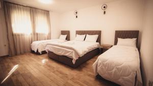 a bedroom with two beds and a window at Saint Sava in Ohrid