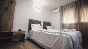 a bedroom with a bed with towels on it at Saint Sava in Ohrid