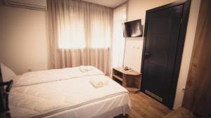 a bedroom with a white bed and a window at Saint Sava in Ohrid