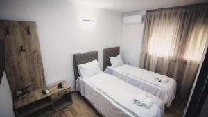 a hotel room with two beds and a window at Saint Sava in Ohrid +22 photos