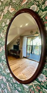 a mirror hanging on a wall in a room at The Coach House in Torpoint