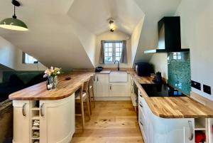 a kitchen with wooden counter tops in a room at The Coach House in Torpoint