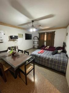 a bedroom with a bed and a table in it at Dulce Hogar 2 in La Banda