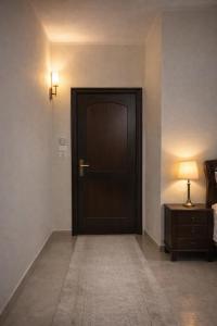 a door in a room with a lamp on a table at Luxor flats and apartments in Luxor