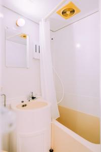 a bathroom with a sink and a mirror at Chic Nakasu Apartment Perfect for 2 Guests in Fukuoka