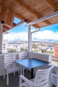 a blue table and chairs on a balcony with a view at Velora Apartments Ksamil in Ksamil
