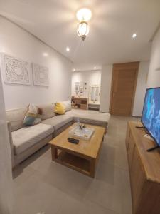 a living room with a couch and a coffee table at Princess Mayfer in Maarif