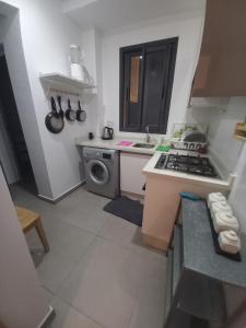 a small kitchen with a stove and a sink at Princess Mayfer in Maarif