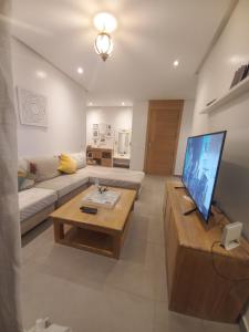 a living room with a couch and a coffee table at Princess Mayfer in Maarif +4 photos