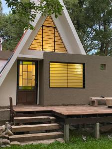 a small house with a triangular roof and a door at Estrellita Mia in Villa Ciudad Parque +3 photos