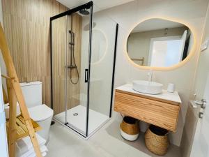 a bathroom with a toilet and a sink and a mirror at RÍA LIVING - Arena 01 in Cee +11 photos