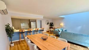 a living room with a wooden table and chairs at SixtySix at Cape View in Broadwater