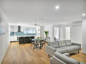 a living room with a couch and a table at Bentleigh Motor Inn - Coffs Harbour in Coffs Harbour