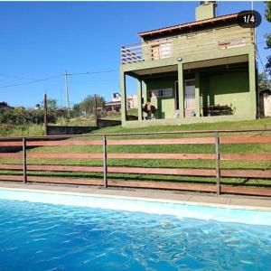 a house with a swimming pool in front of a house at Solanas tanti in Tanti