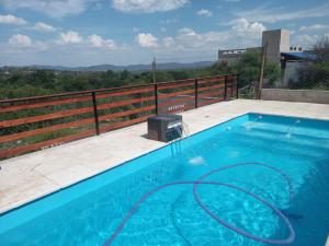 a swimming pool with a hose on a balcony at Solanas tanti in Tanti +4 photos