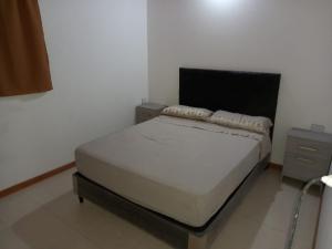 a bedroom with a bed and two night stands at Solanas tanti in Tanti
