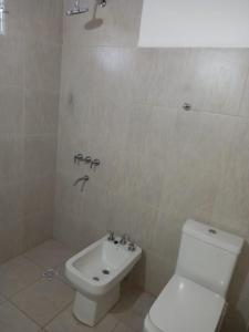 a bathroom with a white toilet and a sink at Solanas tanti in Tanti