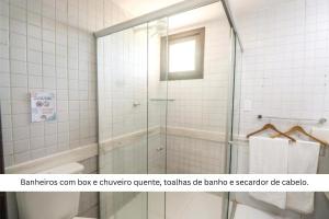a bathroom with a shower with a glass door at Solar Pipa by Pipa Centro in Pipa