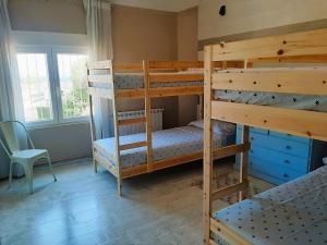 a bedroom with two bunk beds and a desk at Villa Gigi Torre del Sol - 14-18 pers - Coma-Ruga in El Vendrell +50 photos