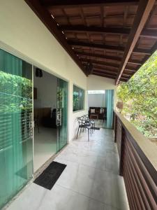 a patio with glass walls and a wooden ceiling at Flat Bluvi Centro de Barra-Grande in Marau