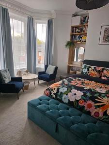 a bedroom with a bed and a blue couch at Shrewsbury in Manchester