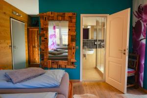 a bathroom with a mirror and a bed in a room at Pension Pulvermühle in Waischenfeld