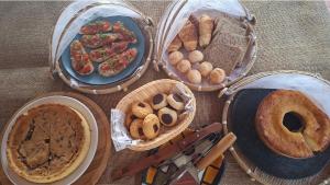 a table topped with baskets of different types of food at Costamar Galinhos in Galinhos