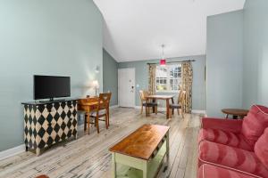 a living room with a couch and a table at Cambria Pines Lodge in Cambria