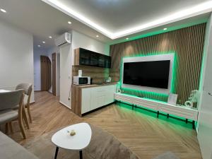 a living room with a large flat screen tv on a wall at Villa Hajdi Q & U in Merano