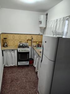 a kitchen with a white refrigerator and a stove at Santa Fe 304 in Gualeguaychú