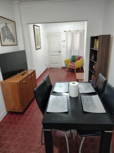 a living room with a dining room table and chairs at Santa Fe 304 in Gualeguaychú