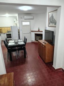 a living room with a table and chairs and a television at Santa Fe 304 in Gualeguaychú
