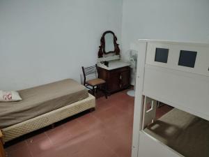 a bedroom with a bed and a vanity and a mirror at Santa Fe 304 in Gualeguaychú