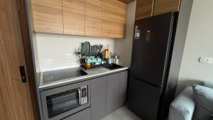 a small kitchen with a sink and a refrigerator at Boho sokhna families only in Ain Sokhna