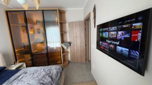 a bedroom with a large flat screen tv on a wall at Boho sokhna families only in Ain Sokhna