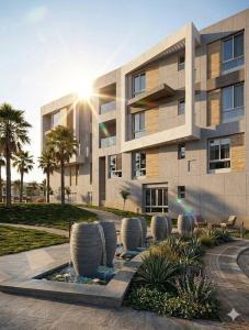 a building with palm trees in front of it at Boho sokhna families only in Ain Sokhna