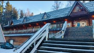 a large building with stairs in front of it at Hotel Karkonosze in Karpacz