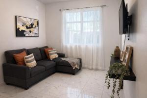 a living room with a couch and a window at La Casita del Este in Fajardo