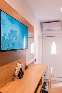 a living room with a large flat screen tv on a wall at Velora Apartments Ksamil in Ksamil