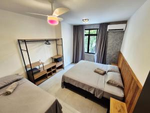 a bedroom with two beds and a mirror at Ceci House - Santa Cecília in São Paulo