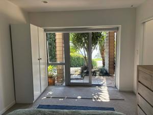 an open door into a home with blue rugs at The Beach House in Red Beach +24 photos
