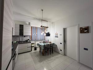 a kitchen with a table and some chairs in it at Appartamento bilocale in Cecina