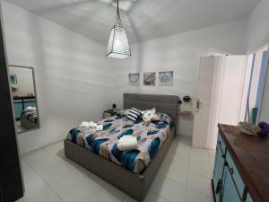 a bedroom with a bed with towels on it at Appartamento bilocale in Cecina