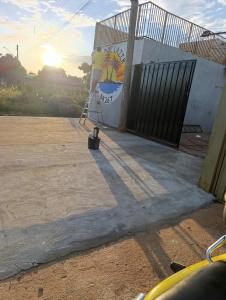 a building with a gate and a painting on the wall at Área de Lazer BR 267 in Bataguaçu