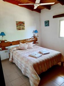 a bedroom with a bed with two towels on it at Cabañas Tinku del Sol in Casa Grande +26 photos