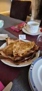 a plate of food with a sandwich on a table at Manoir De Keringant in Saint-Quay-Perros +51 photos