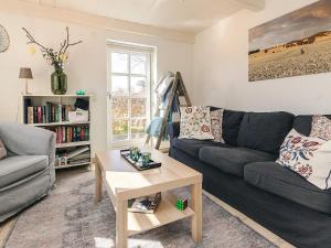 a living room with a couch and a table at 6 person holiday home in Humble-By Traum in Humble