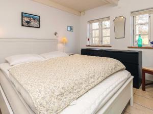 a bedroom with a large white bed in a room at 6 person holiday home in Humble-By Traum in Humble