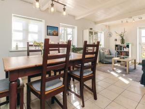 a dining room and living room with a table and chairs at 6 person holiday home in Humble-By Traum in Humble