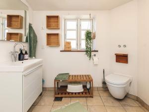a bathroom with a toilet and a table on the floor at 6 person holiday home in Humble-By Traum in Humble +31 photos